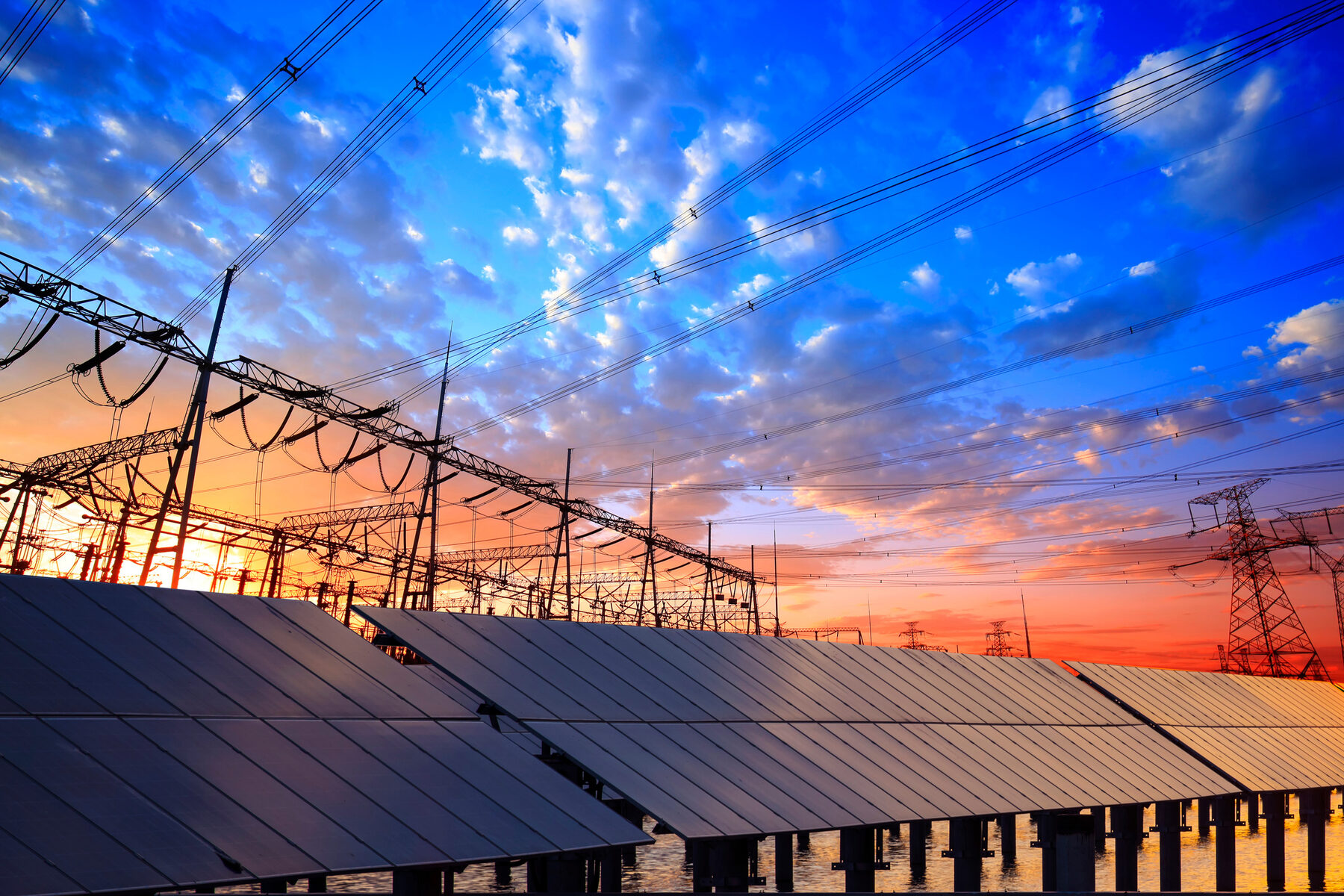Solar arrays and transmission lines at dusk